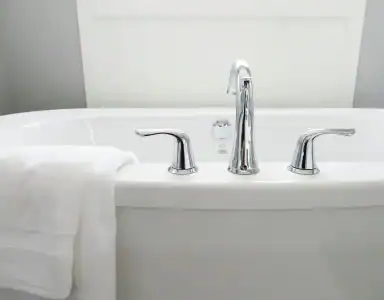 Polished bathtub with chrome fixtures, clean and ready for use, professional cleaning service NYC, Bath cleaning experts.