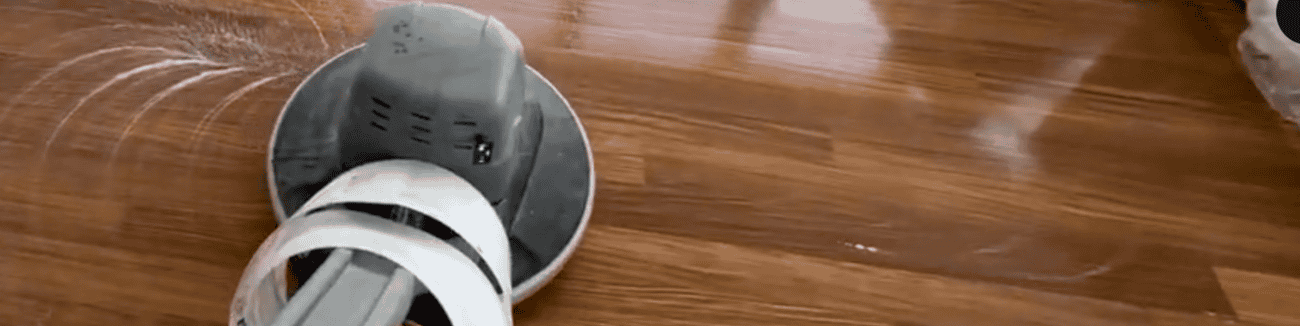 Professional floor buffing machine cleaning and polishing hardwood floors in commercial space