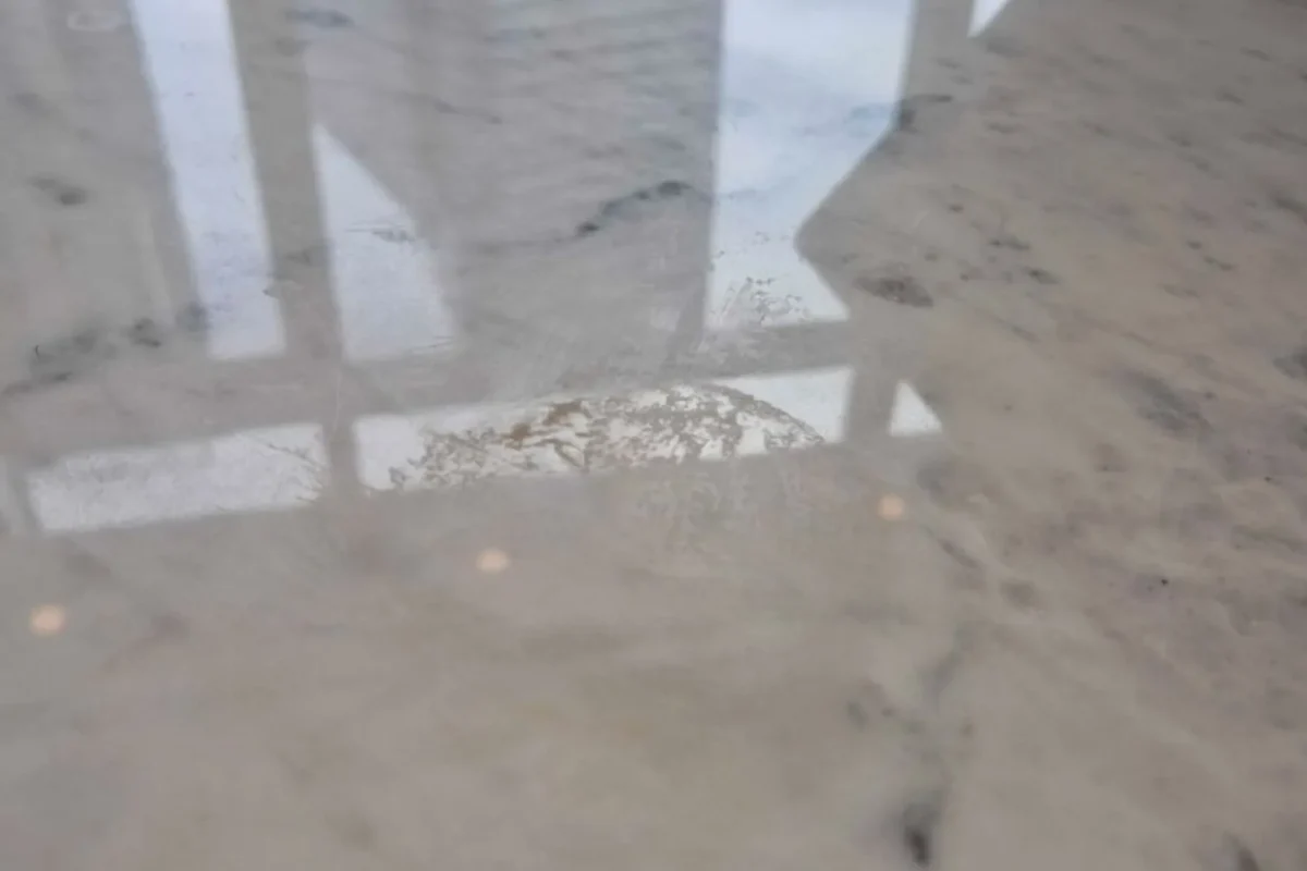 Crumbs and food debris scattered on marble floor before Airbnb turnover cleaning in NYC