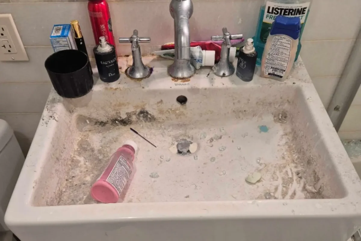Bathroom sink with debris and built-up residue before a Cleaning Chief deep clean in a New York City apartment