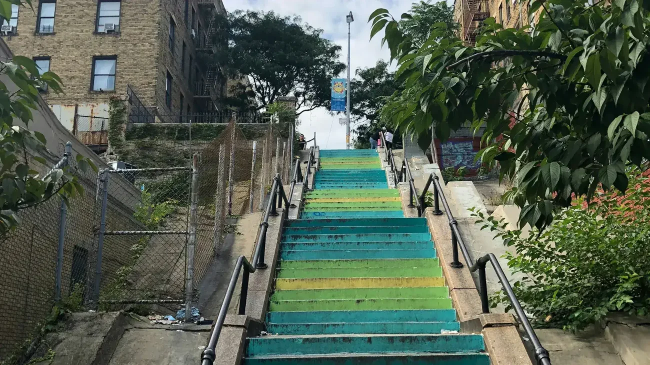 Colorful painted step street in the Bronx with apartment buildings on either side