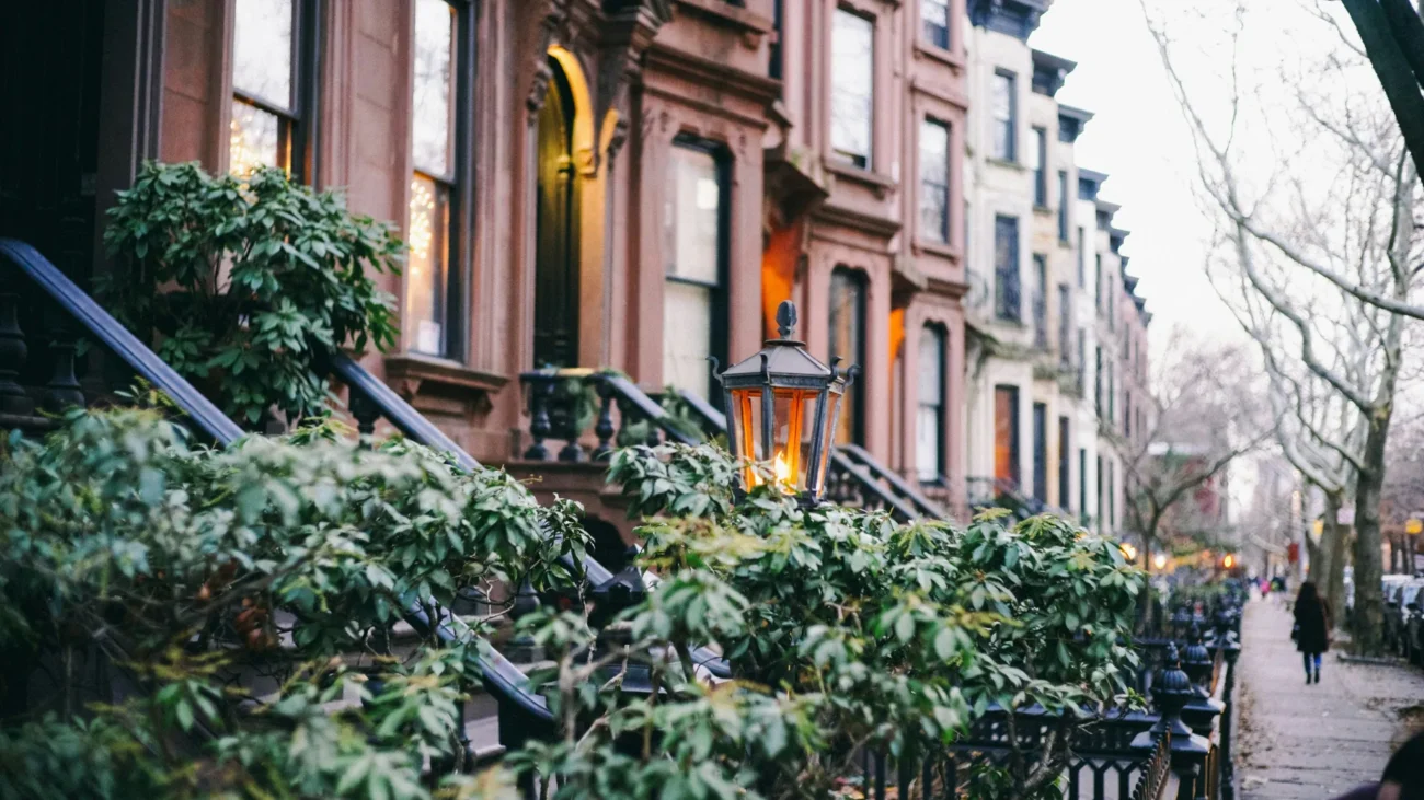 Classic Brooklyn brownstone row houses with stoops and lanterns on a quiet residential block