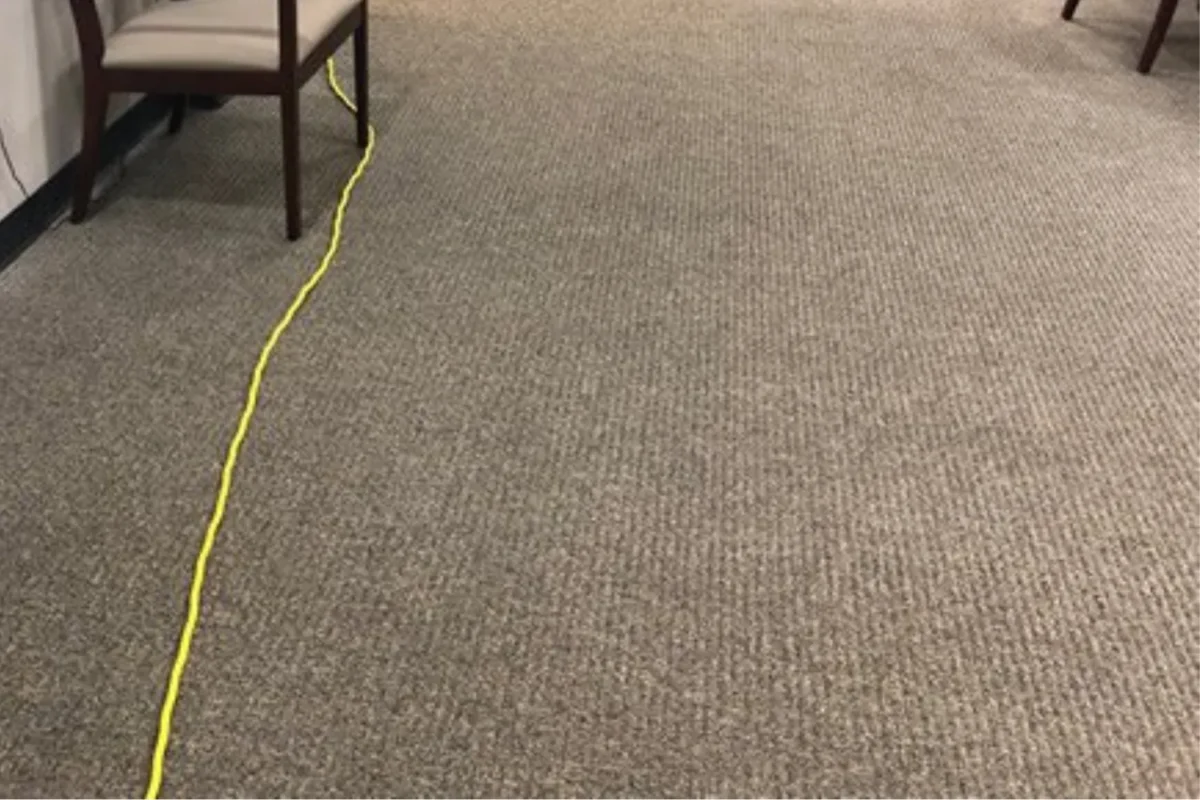 Same beige loop-pile office carpet with stain completely removed and uniform color restored after commercial cleaning