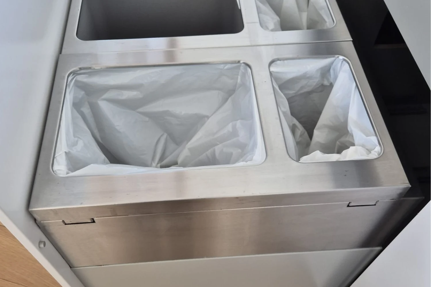 Polished stainless steel kitchen trash bins after Cleaning Chief VIP deep clean