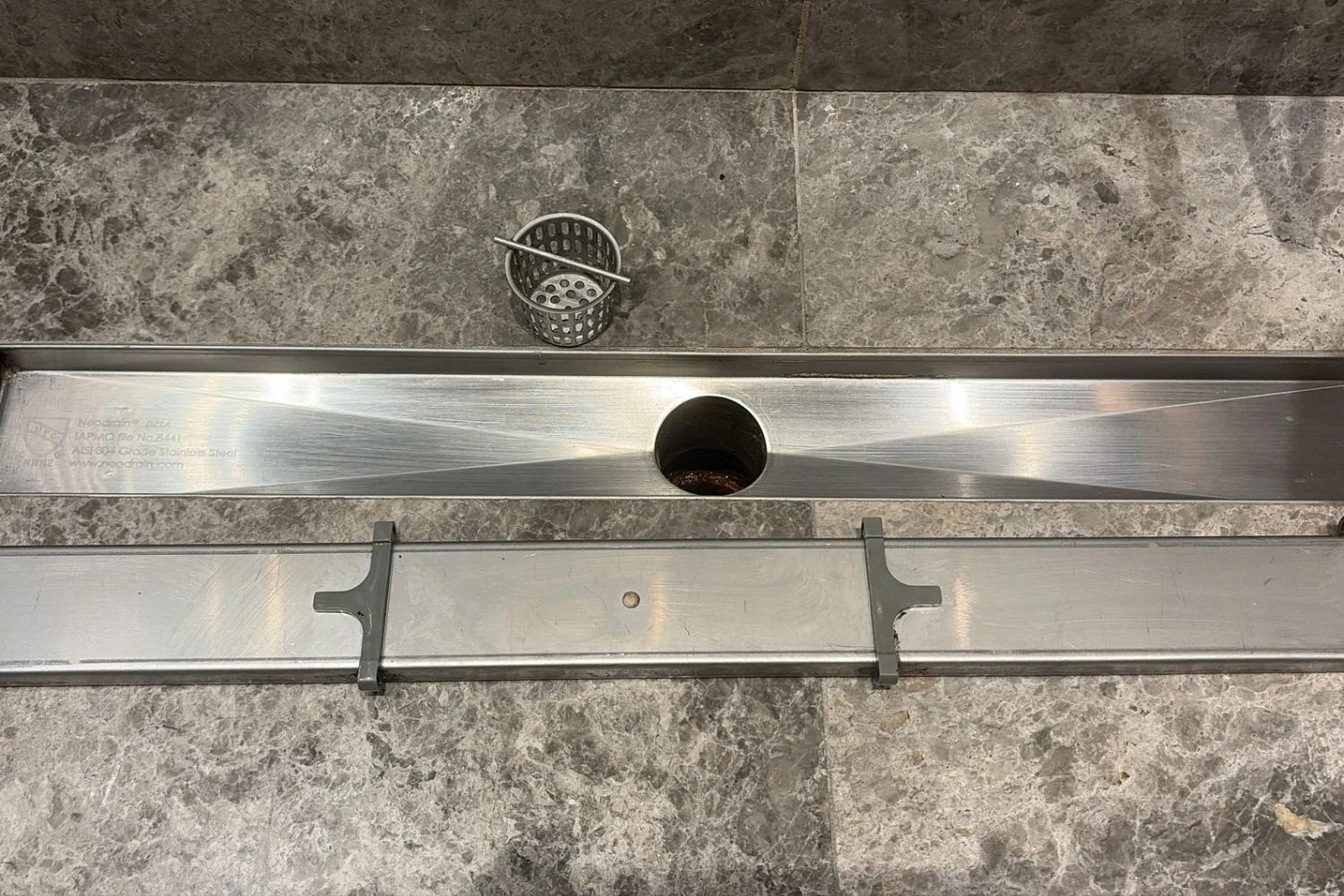 Polished spotless shower drain after Cleaning Chief VIP bathroom deep clean