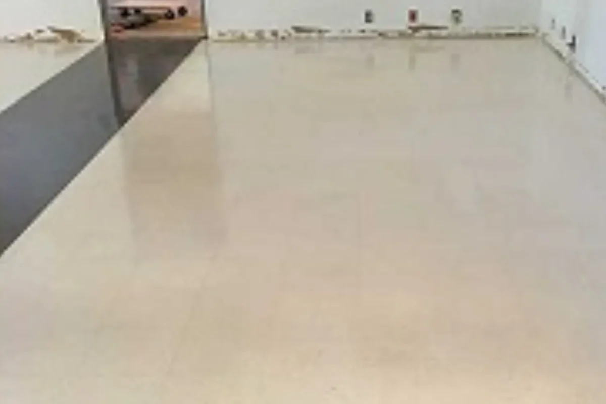 Same commercial space with clean polished light tile floor completely cleared of debris after commercial deep cleaning