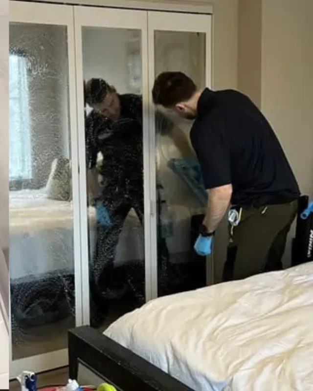 Cleaning Chief cleaner wiping large mirrored wardrobe doors in a NYC bedroom