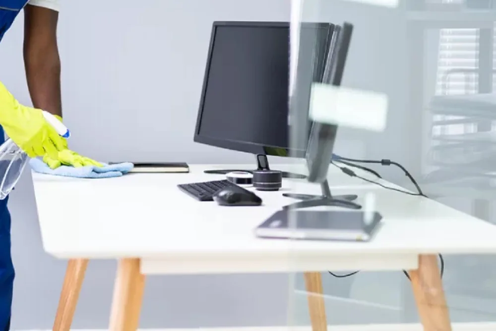 Cleaning Chief professional performing desk and workspace cleaning in NYC