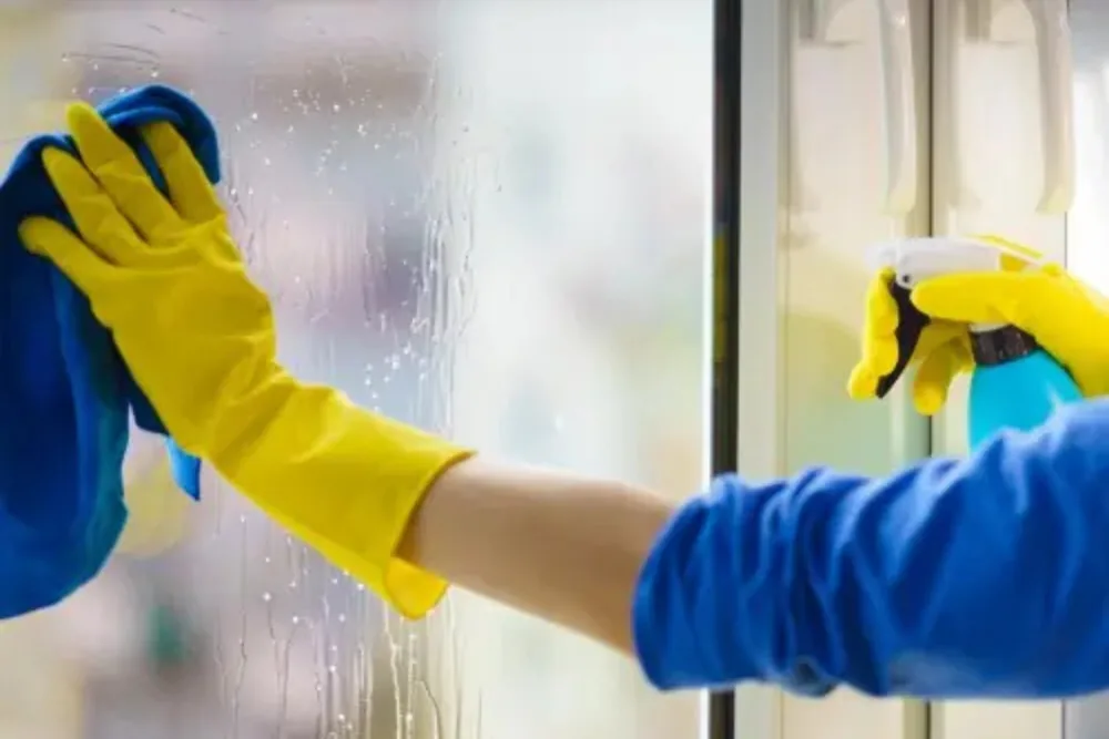 Cleaning Chief professional performing glass and partition spot cleaning in NYC