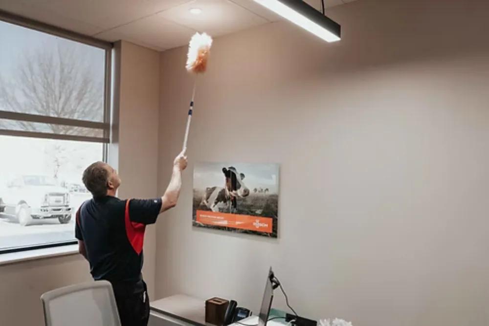 Cleaning Chief professional performing high-dusting and ceiling vent cleaning in NYC