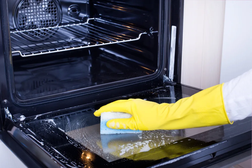 Cleaning Chief professional performing inside oven cleaning in NYC