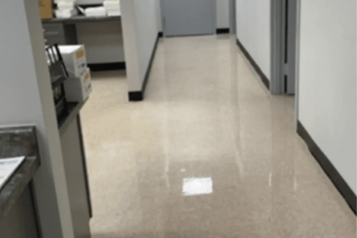 Same office corridor with gleaming reflective vinyl tile floor after janitorial service in NYC