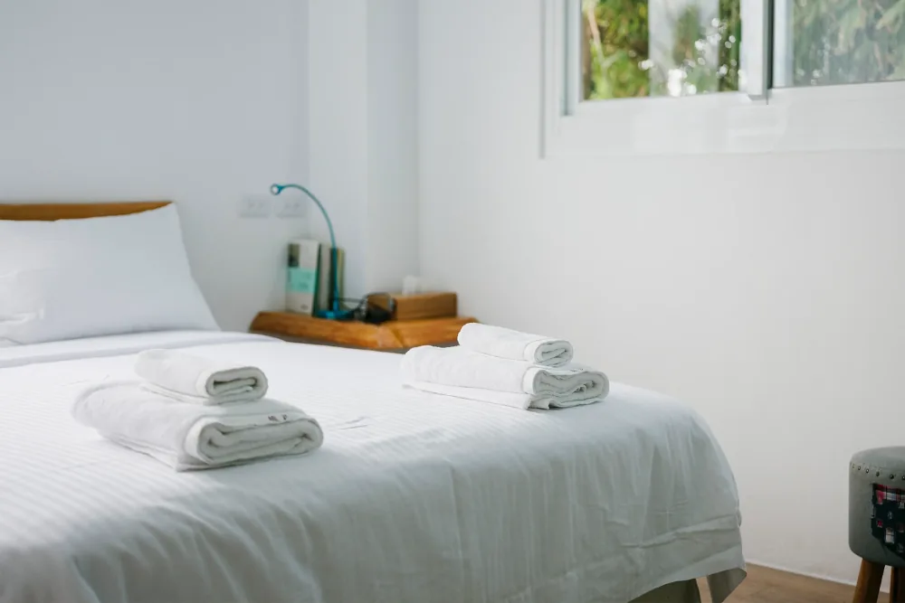 Cleaning Chief professional performing linen change and hotel-style bed making in NYC