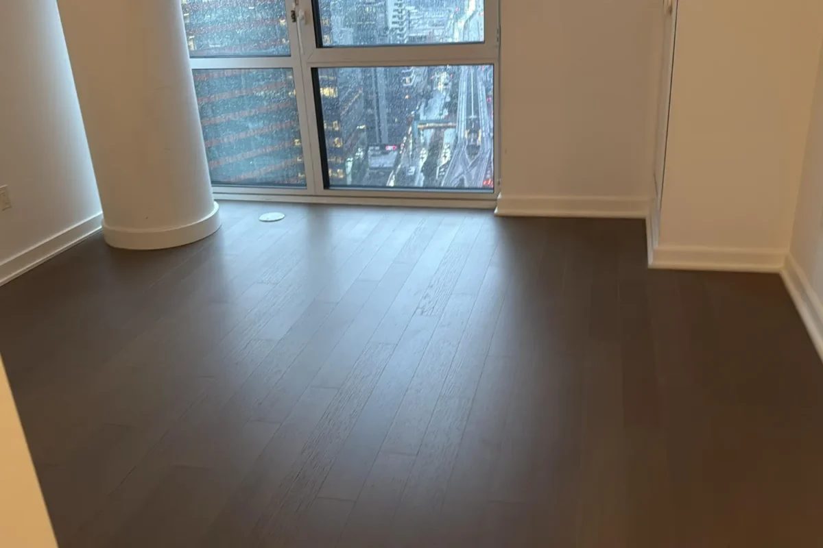Spotless empty NYC apartment room with clean hardwood floor ready for move-in