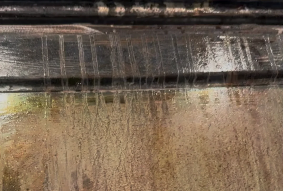 Oven interior with heavy brown and black grease and carbon buildup before move-out cleaning in NYC