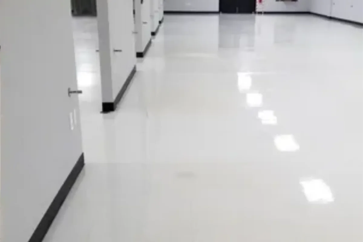 Same large commercial space with gleaming high-gloss polished floor and multiple light reflections after office cleaning