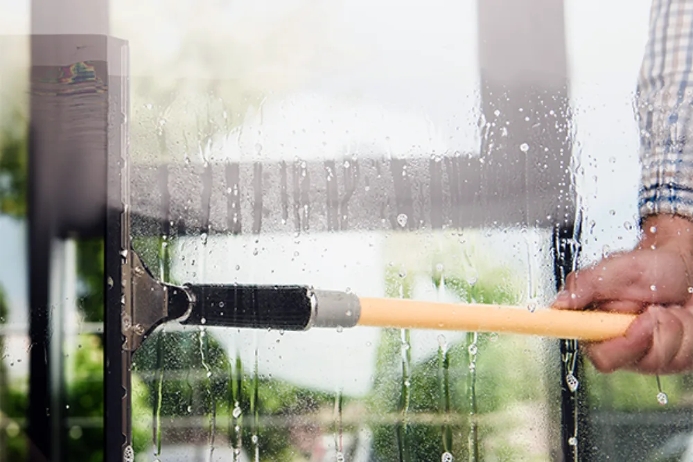 Cleaning Chief professional performing office interior window cleaning in NYC