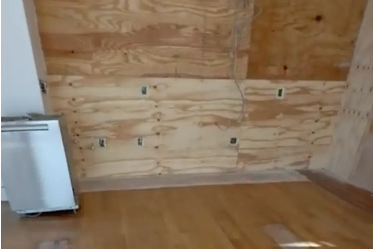 Same room fully cleared of all construction materials with clean hardwood floor after post-construction cleaning