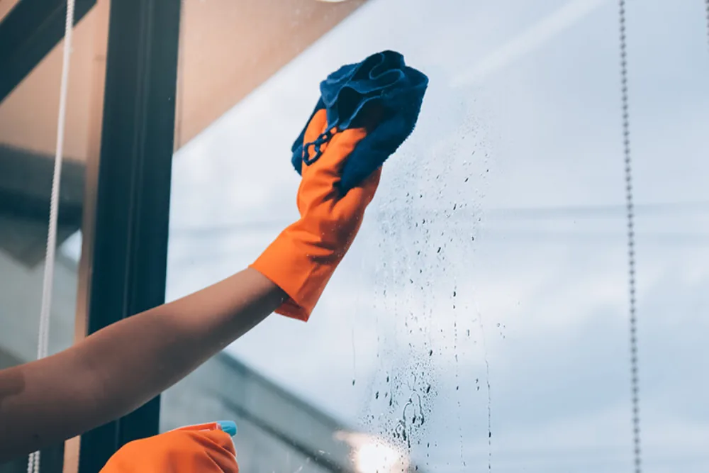 Cleaning Chief professional performing post-construction glass cleaning in NYC