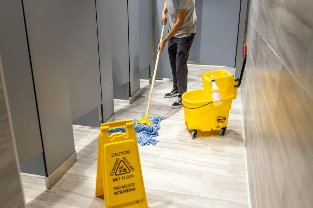 Cleaning Chief professional performing restroom deep sanitation in NYC