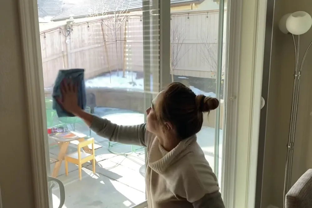 Cleaning Chief professional performing sliding door glass cleaning in NYC
