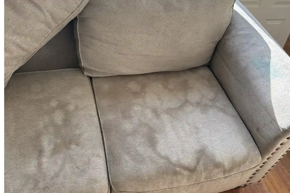 Heavily stained couch before upholstery cleaning by Cleaning Chief in a New York City home.