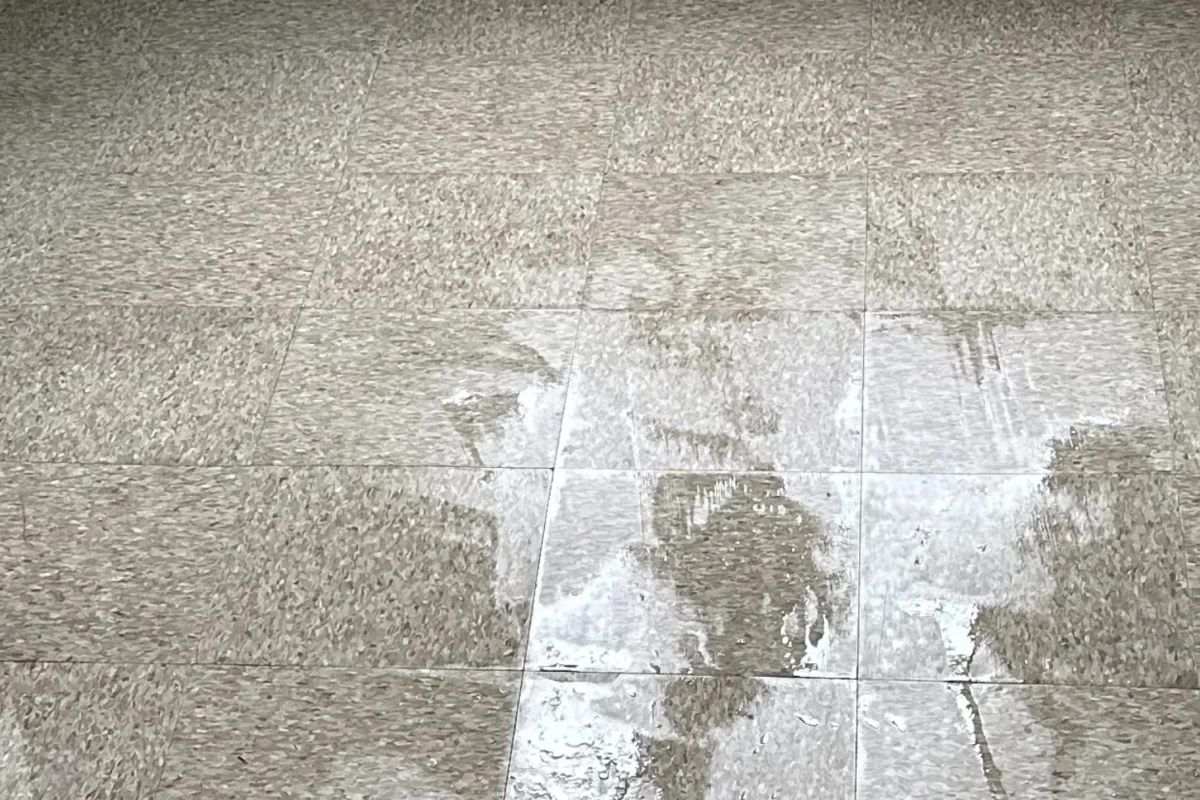 Large stone floor tiles clean and reflective with all grime fully removed after Cleaning Chief tile service