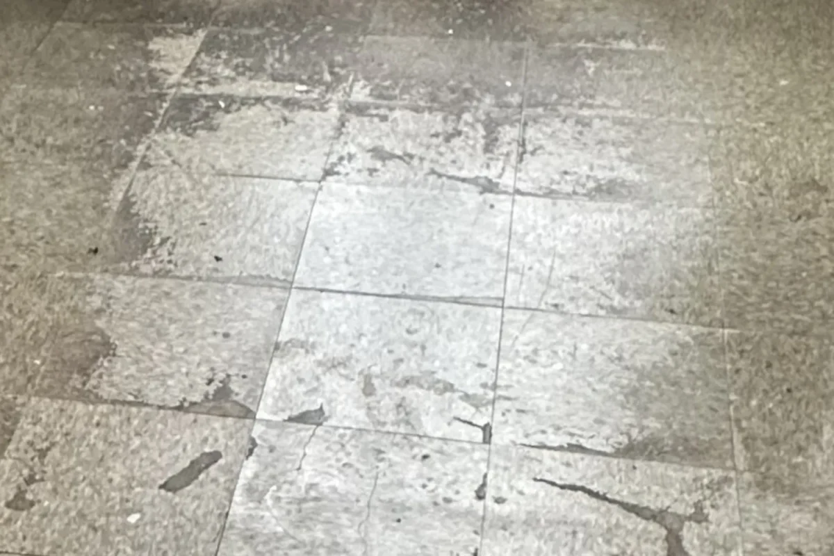 Large stone floor tiles covered in dried dirt and mineral deposits before tile cleaning in NYC
