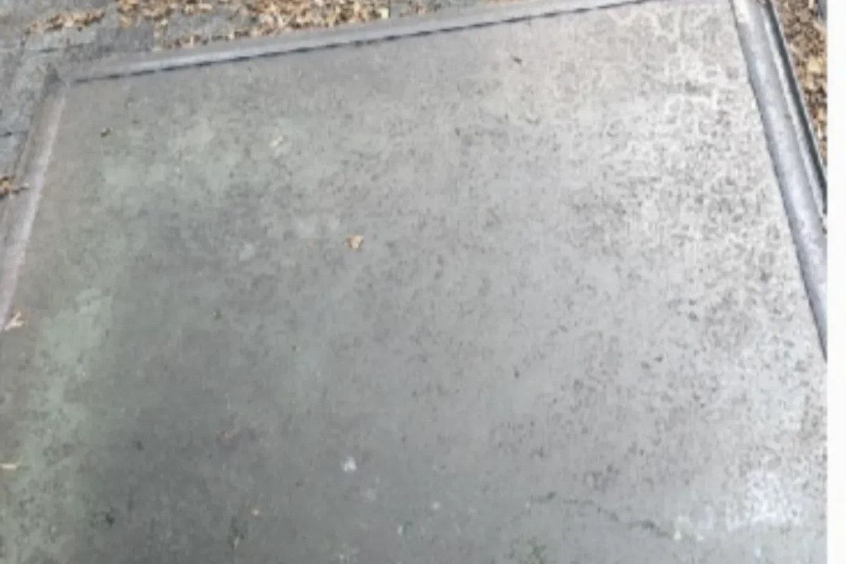 Exterior concrete window ledge covered in city grime and pollution buildup before window cleaning in NYC