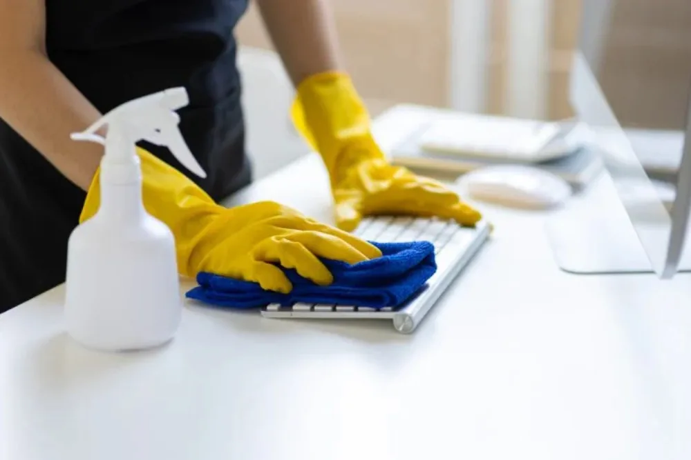 Cleaning Chief professional performing workstation and desk cleaning in NYC